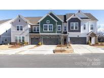 Attractive townhomes feature varied siding, stone accents, and attached garages at 8125 Houser St, Cornelius, NC 28031