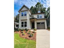 Charming two-story home with a manicured lawn, inviting curb appeal, and attached one car garage at 1912 St John St, Charlotte, NC 28216