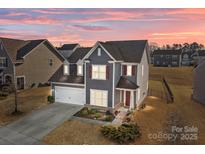 Charming two-story home with a well-maintained lawn and inviting entrance, perfect for a growing Gathering at 2025 Killian Creek Dr, Denver, NC 28037