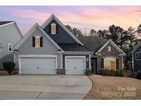 Two-story home with gray and dark siding, two-car garage, and landscaping at 245 Sweet Briar Dr, Fort Mill, SC 29707