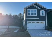 Two-story home with gray siding, white trim, and two-car garage at 284 Laura Elizabeth Ln, Clover, SC 29710