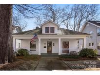 Charming home with a cozy front porch and American flag at 413 W 5Th Ave, Gastonia, NC 28052