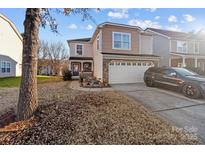 Two-story house with attached garage and landscaping at 5124 Stone Park Dr, Charlotte, NC 28269