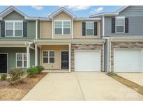 Two-story townhome with attached garage and neutral color scheme at 6340 Revolutionary Trl, Charlotte, NC 28217