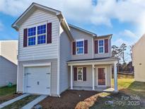 Two-story house with gray siding, maroon accents, and a two-car garage at 6621 Pennacook Dr, Charlotte, NC 28214