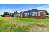 Brick building with large windows and a spacious yard at 1318 Ostwalt Amity Rd, Cleveland, NC 27013