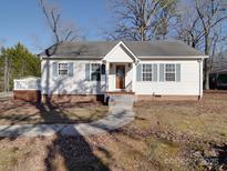 White single story home with gray roof, steps, and small front yard at 141 Linwood Dr, Albemarle, NC 28001