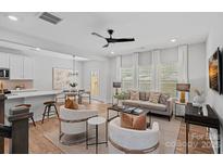 Bright living room with modern furniture, wood floors, and lots of natural light at 19765 Feriba Pl, Cornelius, NC 28031
