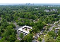 Aerial view of a modern apartment building nestled in a lush, tree-lined neighborhood at 2000 Patio Ct # 108, Charlotte, NC 28205