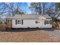 Charming single-story home with white siding, black shutters, and a well-maintained front yard at 3411 Rogers St, Charlotte, NC 28208