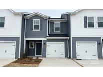 Charming townhome featuring a one-car garage and a welcoming front entrance at 3500 Backwater St, Concord, NC 28027