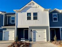 Two-story townhome with gray and white siding, two-car garage, and landscaping at 3510 Backwater St, Concord, NC 28027