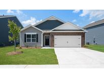 Charming single-story home showcasing a mix of siding, brick accents, and a convenient two-car garage at 4606 Harris Elliot Rd, Lincolnton, NC 28092