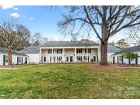Charming townhouse with a large front yard and mature trees offers a welcoming curb appeal at 7000 Quail Hill Rd, Charlotte, NC 28210