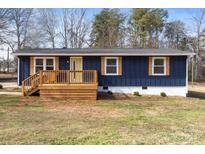 Charming blue home featuring a wood porch, white trim, and well-maintained front yard at 126 Terrace Dr, Bessemer City, NC 28016