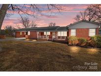 Brick ranch house with carport and porch at 200 11Th St, Spencer, NC 28159