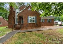 Charming brick home with a well-maintained lawn, inviting entrance, and timeless architectural details at 2000 Shannon Bridge Ln, Matthews, NC 28105