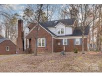 Brick house with gray shutters, and a well-maintained lawn at 2000 Shannon Bridge Ln, Matthews, NC 28105
