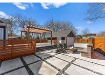 Outdoor oasis boasting a patio, fire pit, pergola, and detached garage at 212 Bacon Ave, Charlotte, NC 28208