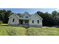 Two-story house with beige siding and a large front yard at 6024 Lake Rd, Mint Hill, NC 28227