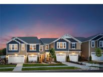 Attractive townhome exterior with two-car garage and landscaping at 7228 Hodges Meadow Ln, Charlotte, NC 28213