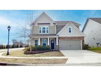 Charming two-story home with stone accents and a well-maintained front yard at 117 Tomahawk Dr, Mooresville, NC 28117