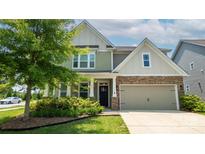 Charming craftsman style home with a two-car garage and manicured front yard at 117 Tomahawk Dr, Mooresville, NC 28117