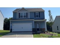 Two-story house with blue siding, white garage door, and landscaping at 1514 Doran Ter, Richburg, SC 29729