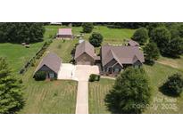 Aerial view of a house, detached garage, and large backyard at 1519 Triplett Rd, Cleveland, NC 27013