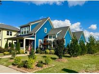 Beautiful blue two-story house with a nicely landscaped front yard at 1575 Riverwalk Pkwy, Rock Hill, SC 29730