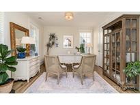 Bright office space featuring a white desk, ornate mirror, stylish chairs and custom cabinet for a functional and elegant work area at 1575 Riverwalk Pkwy, Rock Hill, SC 29730