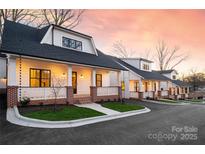 Row of charming homes with brick and white siding at 2002 Summey Ave # 3, Charlotte, NC 28205