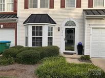 Inviting exterior featuring a bay window and well-manicured landscaping at 3818 Carl Parmer Dr, Harrisburg, NC 28075