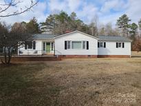 White Ranch home with large yard and mature trees at 796 S Lincoln S St, Dallas, NC 28034