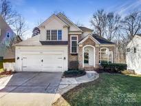 Two-story house with white siding, brick accents, and a two-car garage at 8806 Glenside St, Huntersville, NC 28078