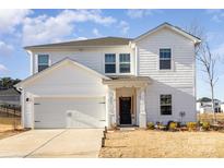 Two-story white house with a two-car garage and landscaped yard at 1703 High Point Ter, Stanley, NC 28164