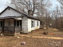 White house with porch and yard needs some TLC at 206 Barnyard Ln, Statesville, NC 28625