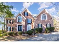 Brick two-story house with a large front yard and landscaping at 2510 Tulip Hill Dr, Charlotte, NC 28270