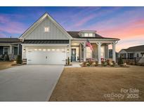 Craftsman style home with gray siding, white trim, and a covered porch at 267 Portrait Way, Indian Trail, NC 28079