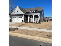 Gray Craftsman style home with a white front door and porch at 267 Portrait Way, Indian Trail, NC 28079