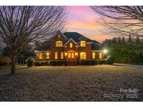 Brick two-story house with large windows and landscaping at 4421 Windwood Cir, Charlotte, NC 28226