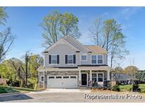 Two-story house with stone accents and a two-car garage at 5011 Mooreland Oaks Way # 3P, Mount Holly, NC 28120
