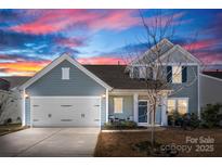 Charming two-story home with a two-car garage, manicured lawn, and inviting curb appeal at 5034 Moselle Ave, Fort Mill, SC 29707