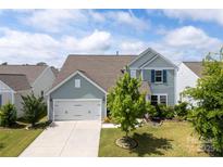 Charming two-story home with a well-manicured lawn, and a two car garage at 5034 Moselle Ave, Fort Mill, SC 29707