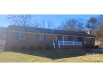 Brick ranch house with covered porch and landscaped yard at 5527 Dallas High Shoals Hwy Hwy, Dallas, NC 28034