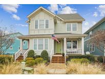 Charming two-story home with inviting front porch, manicured landscaping and bright green door at 746 Waterscape Ct, Rock Hill, SC 29730