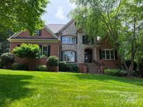 Charming brick and stone home with manicured lawn and lush landscaping at 252 Bay Shore Loop, Mooresville, NC 28117