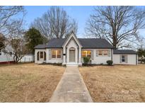 Newly renovated craftsman home with gray painted brick and a landscaped lawn at 315 W 2Nd St, Cherryville, NC 28021