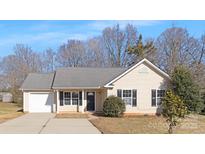 Beige house with gray roof, black shutters, and a driveway at 4321 Bobterry Ct, Charlotte, NC 28216