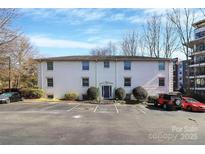 Classic white brick building with manicured landscaping and convenient parking at 4923 Park Rd # D, Charlotte, NC 28209